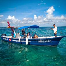 a group of people riding on the back of a boat in the water